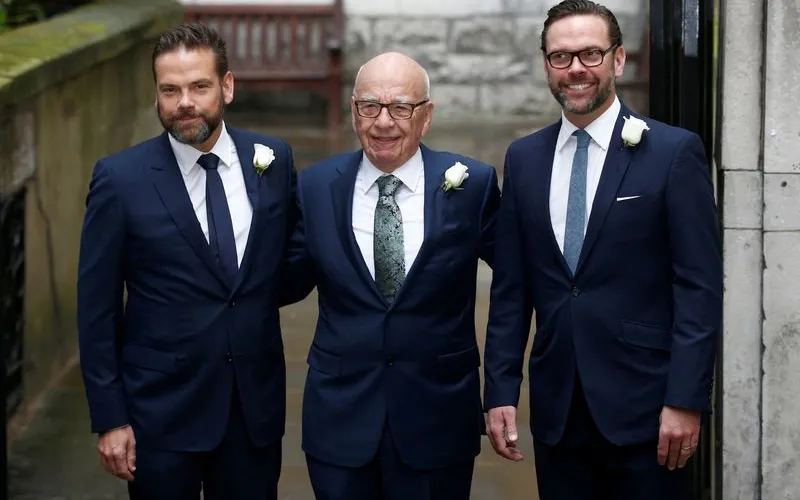 Rupert Murdoch flanked by sons Lachlan and James outside St Bride's church in London