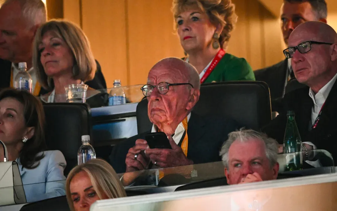 Rupert Murdoch standing at the Republican National Convention surrounded by attendees