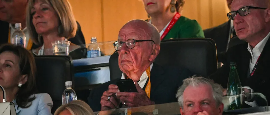 Rupert Murdoch standing at the Republican National Convention surrounded by attendees